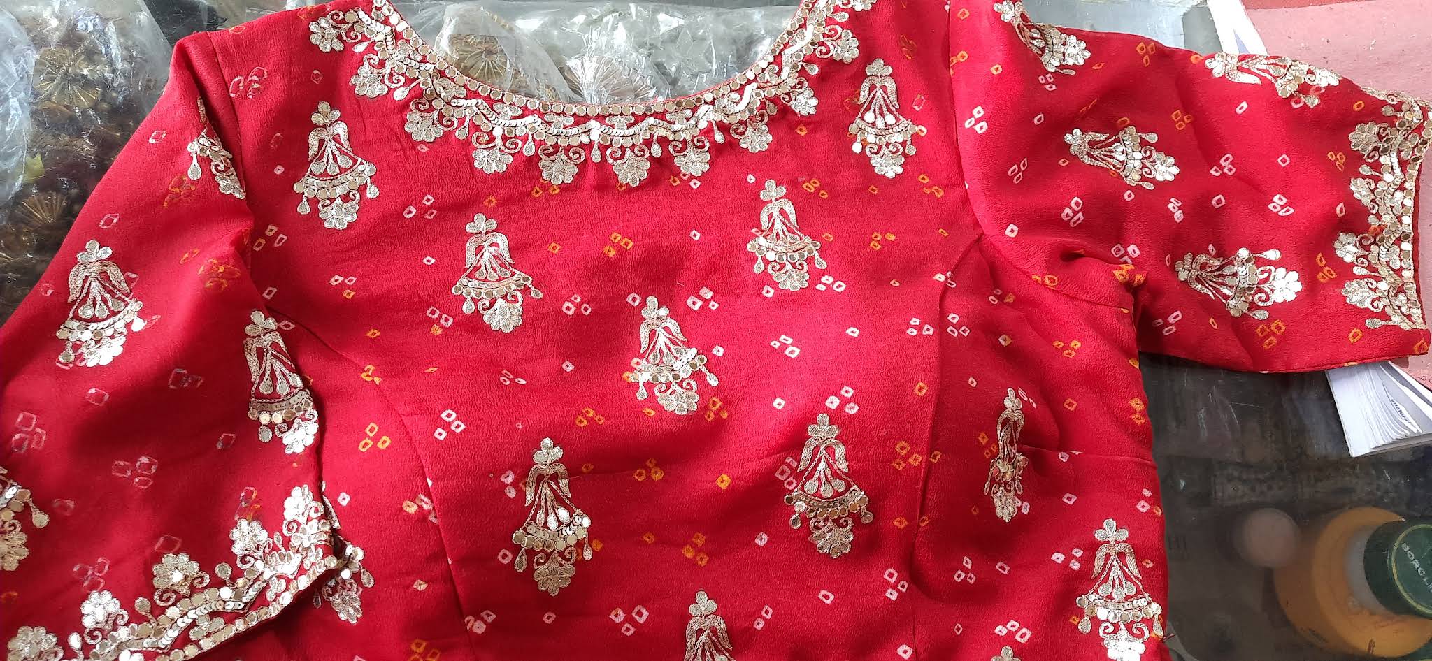 Gold embroidery on a red designer blouse