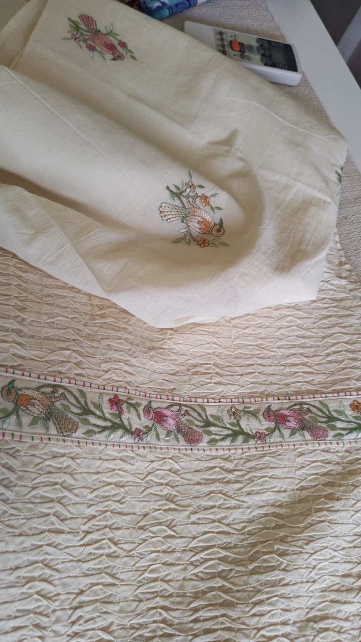 Pastel flowers and delicate embroidery on ivory fabric